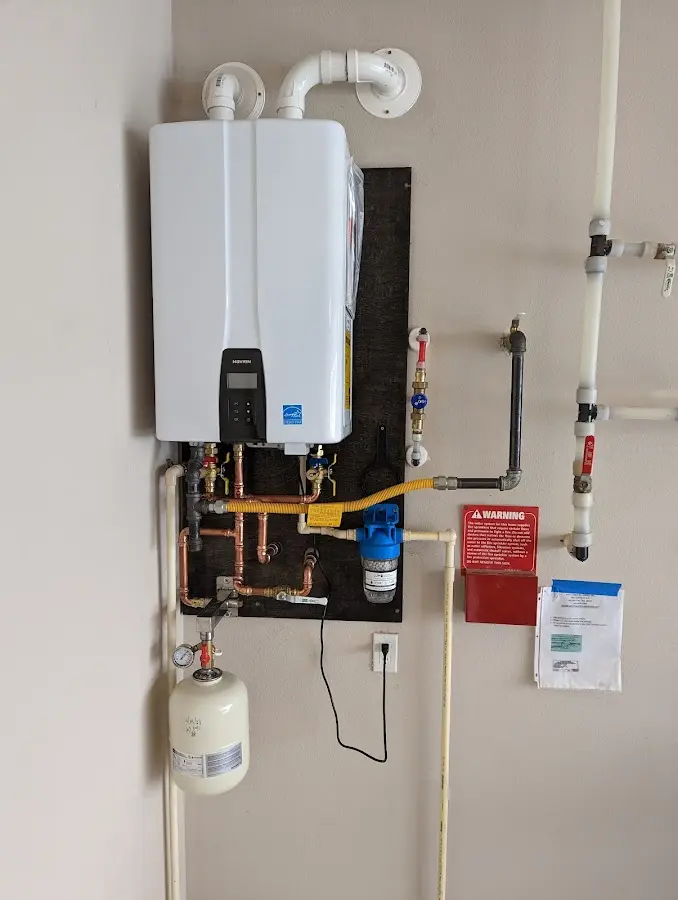 Professional plumber installing copper piping in a Kenton home